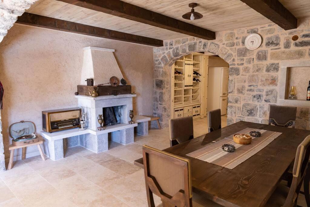 Interior dining room with stone walls and antique fireplace