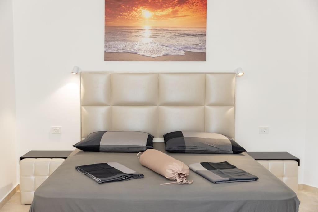 Calm bedroom with sea-sunset artwork